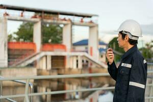 maintenance and inspection. Maintenance engineers are using walky talky to inform the results of inspections of buildings and structures. Irrigation engineers are exploring sluice systems photo