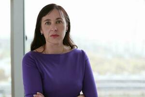 Portrait of a middle-aged woman in a purple dress. photo