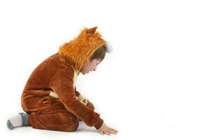 On a white background funny boy in a fur lion suit. photo