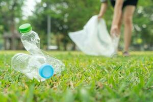 Save earth. Volunteer pick up trash garbage at the park and plastic bottles are difficult decompose prevent harm. Earth, Environment, Greening planet, reduce global warming, Save world ,pollution photo