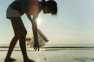 Save water. Volunteer pick up trash garbage at the beach and plastic bottles are difficult decompose prevent harm aquatic life. Earth, Environment, Greening planet, reduce global warming, Save world photo