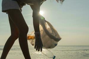 Save ocean. Volunteer pick up trash garbage at the beach and plastic bottles are difficult decompose prevent harm aquatic life. Earth, Environment, Greening planet, reduce global warming, Save world photo