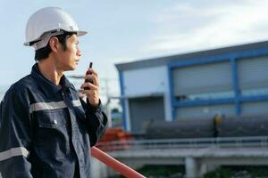 maintenance and inspector. Maintenance engineers are using walky talky to inform the results of inspection of buildings and structures. Irrigation engineers are exploring sluice systems photo