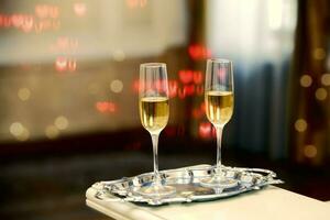 Two glasses of champagne against a background of bokeh spots. Festive romantic background. photo