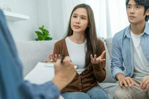 Couple support each while discussing family issues with psychiatrist. Husband encourages and empathy wife suffers depression. psychological, divorce, trust, care, workplace and health issues. photo