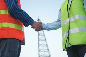 Construction worker team hands shaking greeting start up plan new project contract in office center at construction site, industry ,architecture, partner, teamwork, agreement, property, contacts. photo