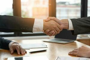 Executives are shaking hand after results success to target. financial data analysis and market growth report chart. Planning Strategies, startup project, profitable strategy, Business meeting time photo