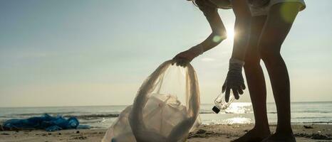 Save ocean. Volunteer pick up trash garbage at the beach and plastic bottles are difficult decompose prevent harm aquatic life. Earth, Environment, Greening planet, reduce global warming, Save world photo
