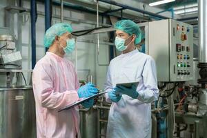 quality supervisor food or beverages technician inspection about quality control food or beverages before send product to the customer. Production leader recheck ingredient and productivity. photo