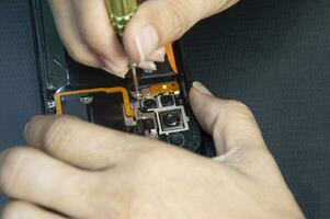 top view, mechanic repairing smartphone photo