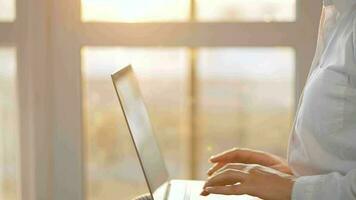 Woman is sitting on the couch and working on a laptop. Concept of remote work video