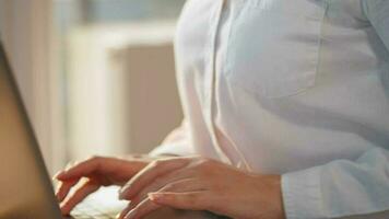 Woman is sitting on the couch and working on a laptop. Concept of remote work video