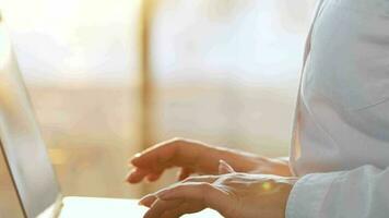 Woman is sitting on the couch and working on a laptop. Concept of remote work video