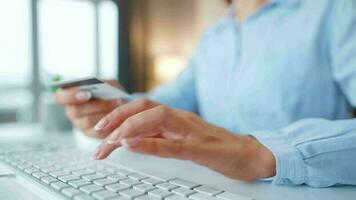 Woman typing credit card number on computer keyboard. She making online purchase. Online payment service. video