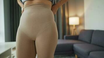 kvinna sätter på bantning underkläder till förbättra kropp silhuett video