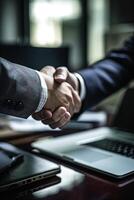 Crop Image of Two Person Shaking Hands Near Laptop on Workplace for Business Meeting. . photo