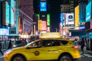 New York City, USA - August 9, 2019-People and tourists stroll among the lights and skyscrapers of Time Square in Manhattan during a summer night photo