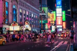 New York City, USA - August 9, 2019-People and tourists stroll among the lights and skyscrapers of Time Square in Manhattan during a summer night photo