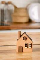 A model of an eco-friendly wooden house in the kitchen with white furniture. photo