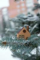 A model of an eco-friendly wooden house on a winter background. photo