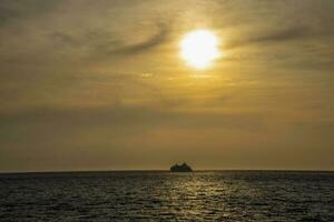 A cruise ship sails into the sunset on a summer day. photo