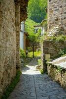 Narrow streets in a Turkish city on a summer and sunny day with old and masonry wooden houses. photo