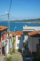 estrecho calles en un turco ciudad en un verano y soleado día con antiguo y albañilería de madera casas foto