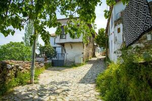 Narrow streets in a Turkish city on a summer and sunny day with old and masonry wooden houses. photo