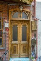 The front door is brown wood, in the old style. photo