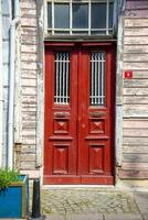 The front door is brown wood, in the old style. photo
