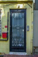 Black metal door with glass and yellow front. photo