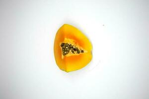 Star-shaped pieces of papaya fruit isolated on white background photo