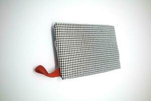 A Wallet with black stripes and mostly white photo
