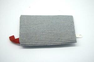 A Wallet with black stripes and mostly white photo