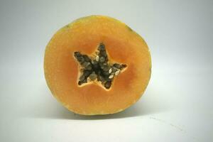Star-shaped pieces of papaya fruit isolated on white background photo