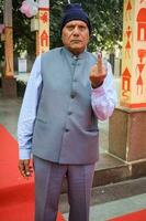 New Delhi, India - March 04 2023 - Unidentified people showing their ink-marked fingers after casting votes in front of polling booth of east Delhi area for MCD local body Elections 2022 photo