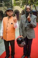 New Delhi, India - March 04 2023 - Unidentified people showing their ink-marked fingers after casting votes in front of polling booth of east Delhi area for MCD local body Elections 2022 photo