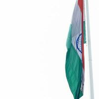 India flag flying high at Connaught Place with pride in blue sky, India flag fluttering, Indian Flag on Independence Day and Republic Day of India, tilt up shot, Waving Indian flag, Har Ghar Tiranga photo