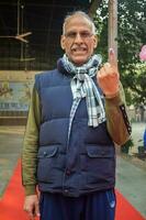 New Delhi, India - May 04 2023 - Unidentified people showing their ink-marked fingers after casting votes in front of polling booth of east Delhi area for MCD local body Elections 2022 photo