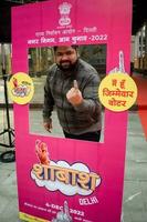 New Delhi, India - May 04 2023 - Unidentified people showing their ink-marked fingers after casting votes in front of polling booth of east Delhi area for MCD local body Elections 2022 photo