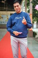 New Delhi, India - May 04 2023 - Unidentified people showing their ink-marked fingers after casting votes in front of polling booth of east Delhi area for MCD local body Elections 2022 photo