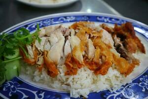 Hainanese fried crispy chicken rice on plate photo