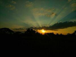 Sunset over the horizon in the evening background. Beautiful sky and clouds. Golden time. photo