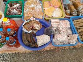 Wild animals and dried food for sale at local market. photo