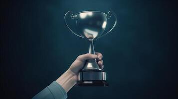 hand holding trophy on dark background photo