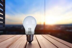 light bulb on wooden table. Soft blurred cloudy blue sky with soft morning light in background. International Day of Light. photo