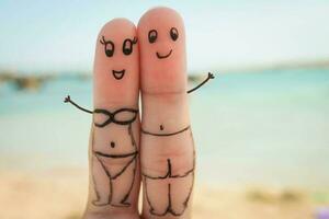 Happy couple have a rest on the beach in bathing suits photo