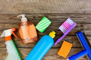 Cleaning products on wooden background. Toned image. Top view. photo