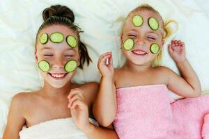 Beautiful girl with facial mask of cucumber. Top view. photo