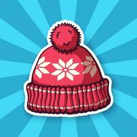 Sticker of red winter hat with pompon and snowflake pattern vector